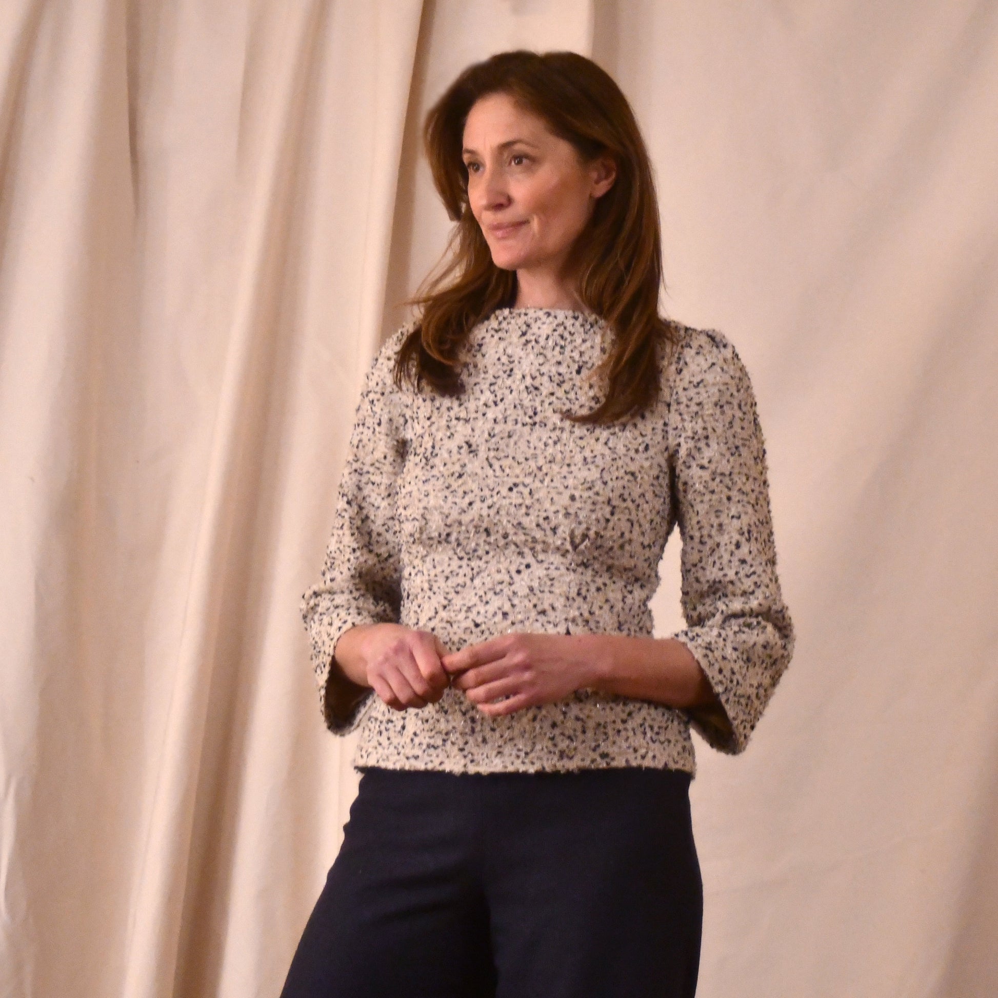 A Tailored Boat Neck Blouse in Linton Tweeds Boucle and a contrasting pair of trouesers. A chic, light-hued two-piece with long sleeves. Handmade in Britain.
