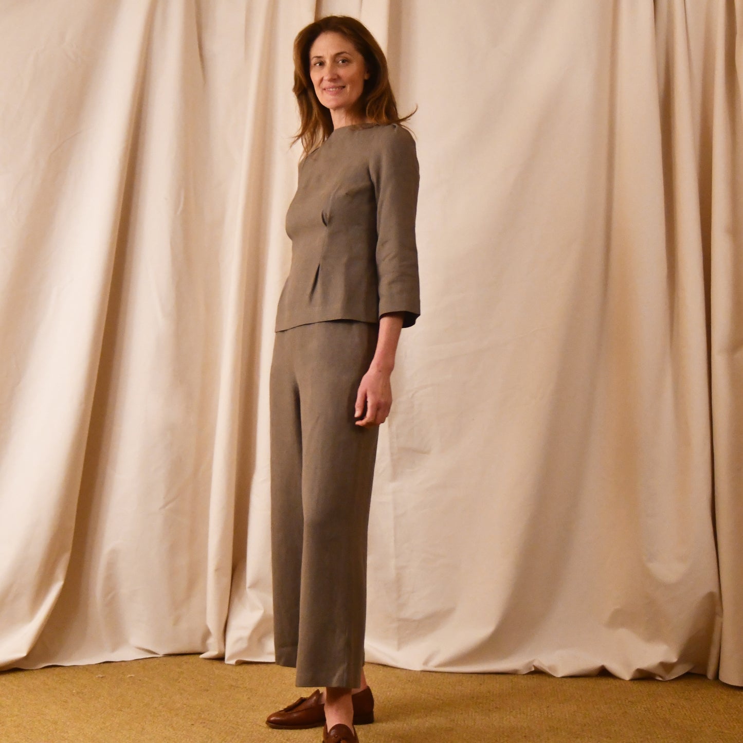 EdNerat’s Tailored Boat Neck Blouse in a slubby Irish linen in a light brown colour.  Handmade in Britain. Shown with matching wide-leg pants.