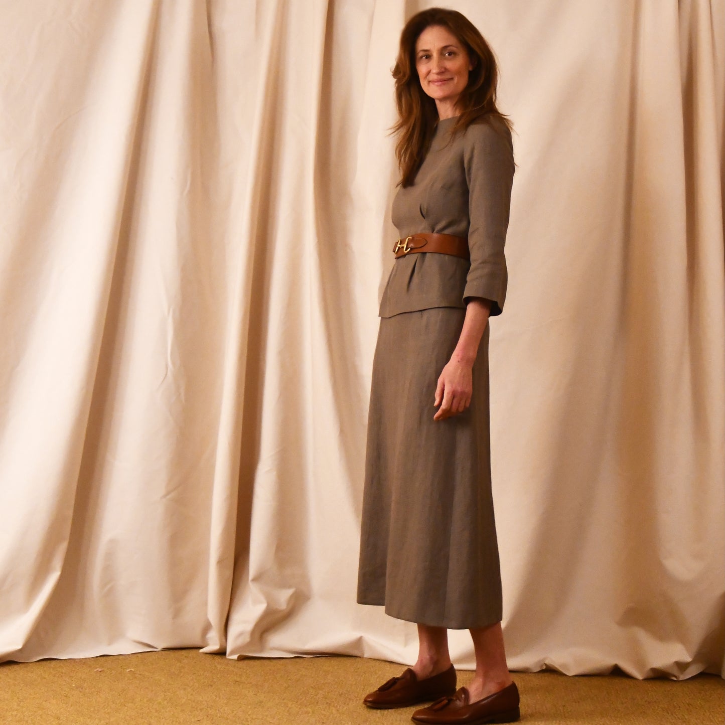A Tailored Boat Neck Blouse in Brown Irish Linen. Fitted and elegant the top is shown over a matching A-Line skirt. Handmade in Britain.