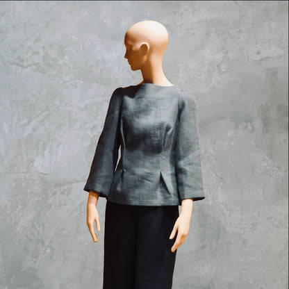 Bespoke Sea Blue Boat Neck Tailored Top  with three quarter sleeves in Slubby Irish Linen. Shown worn over trousers, three quarters view.
Handmade in Britain.