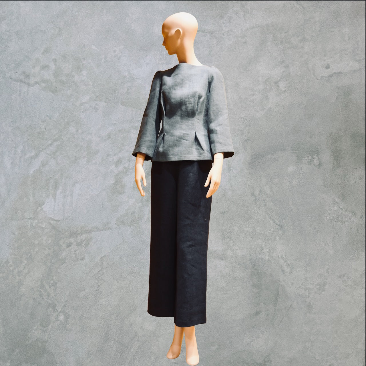 Bespoke Sea Blue Boat Neck Tailored Top  with three quarter sleeves in Slubby Irish Linen. Shown worn over navy linen trousers, full view.
Handmade in Britain.