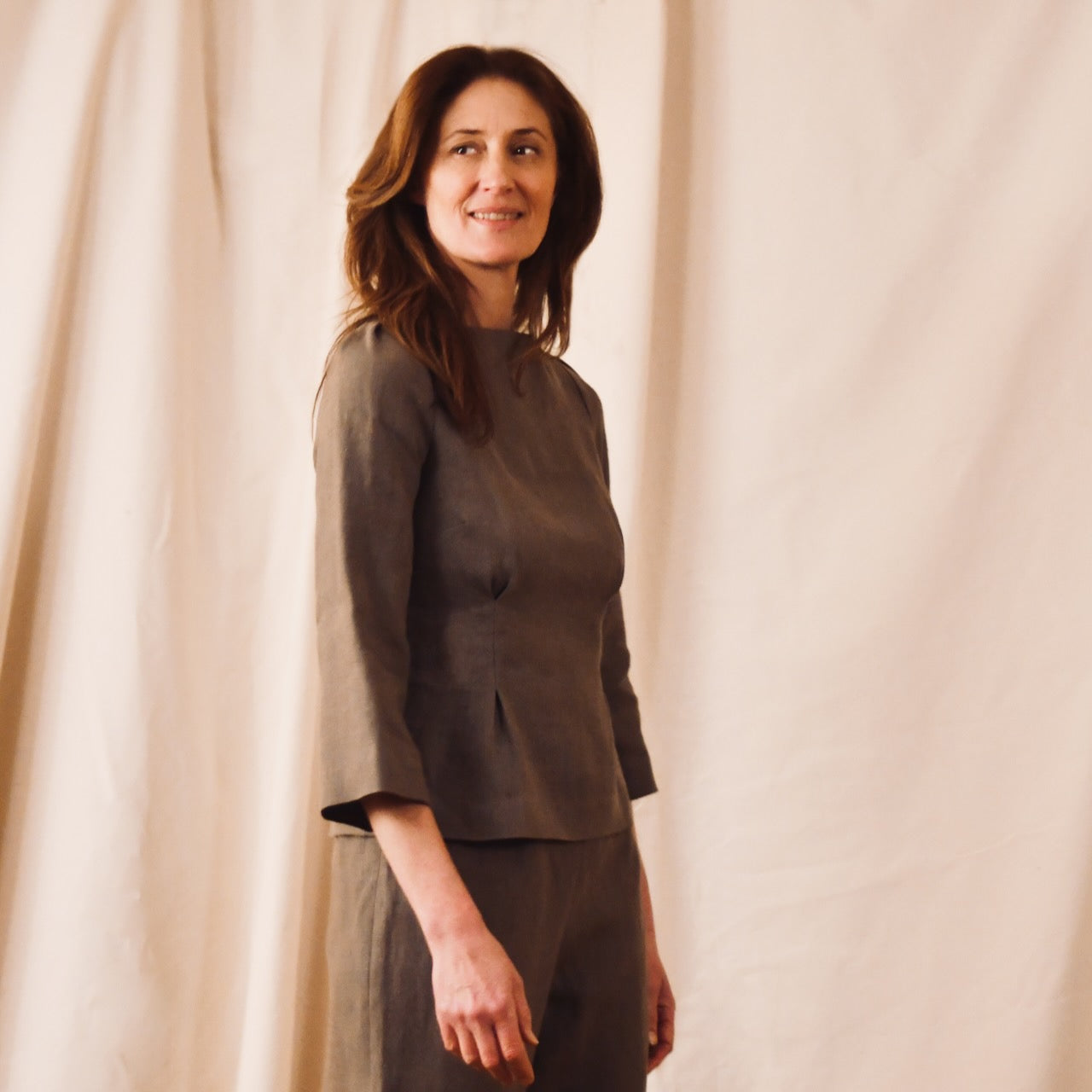 EdNerat’s Tailored Boat Neck Blouse in a slubby Irish linen in a light brown colour.  Handmade in Britain. Shown in close-up