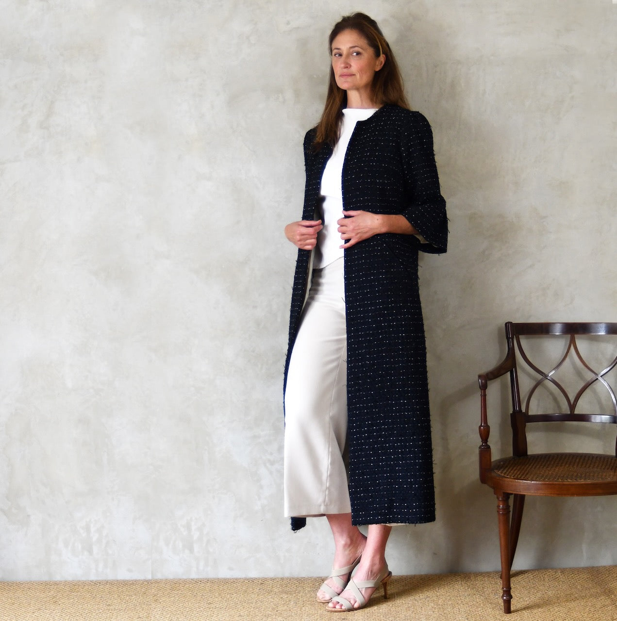 A Bell Sleeved A Line Coat in Navy, Black and White Cotton Boucle from Linton Tweeds. A minimalist but elegant summer coat with three-quarter bell sleeves and an A-Line design. Handmade in Britain. 