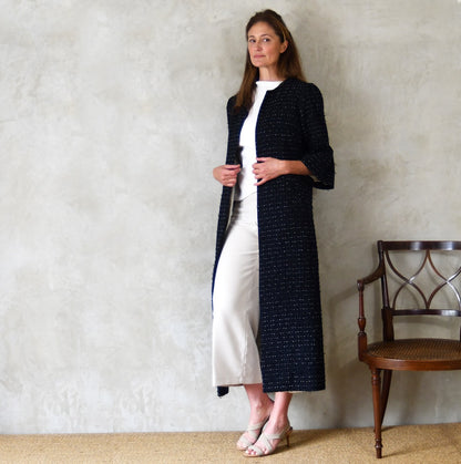 A Bell Sleeved A Line Coat in Navy, Black and White Cotton Boucle from Linton Tweeds. A minimalist but elegant summer coat with three-quarter bell sleeves and an A-Line design. Handmade in Britain. 