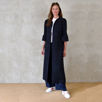 A Bespoke Bell Sleeved A Line Coat in Navy, Black and White Cotton Boucle from Linton Tweeds. A minimalist but elegant summer coat with three-quarter bell sleeves and an A-Line design. Handmade in Britain. 