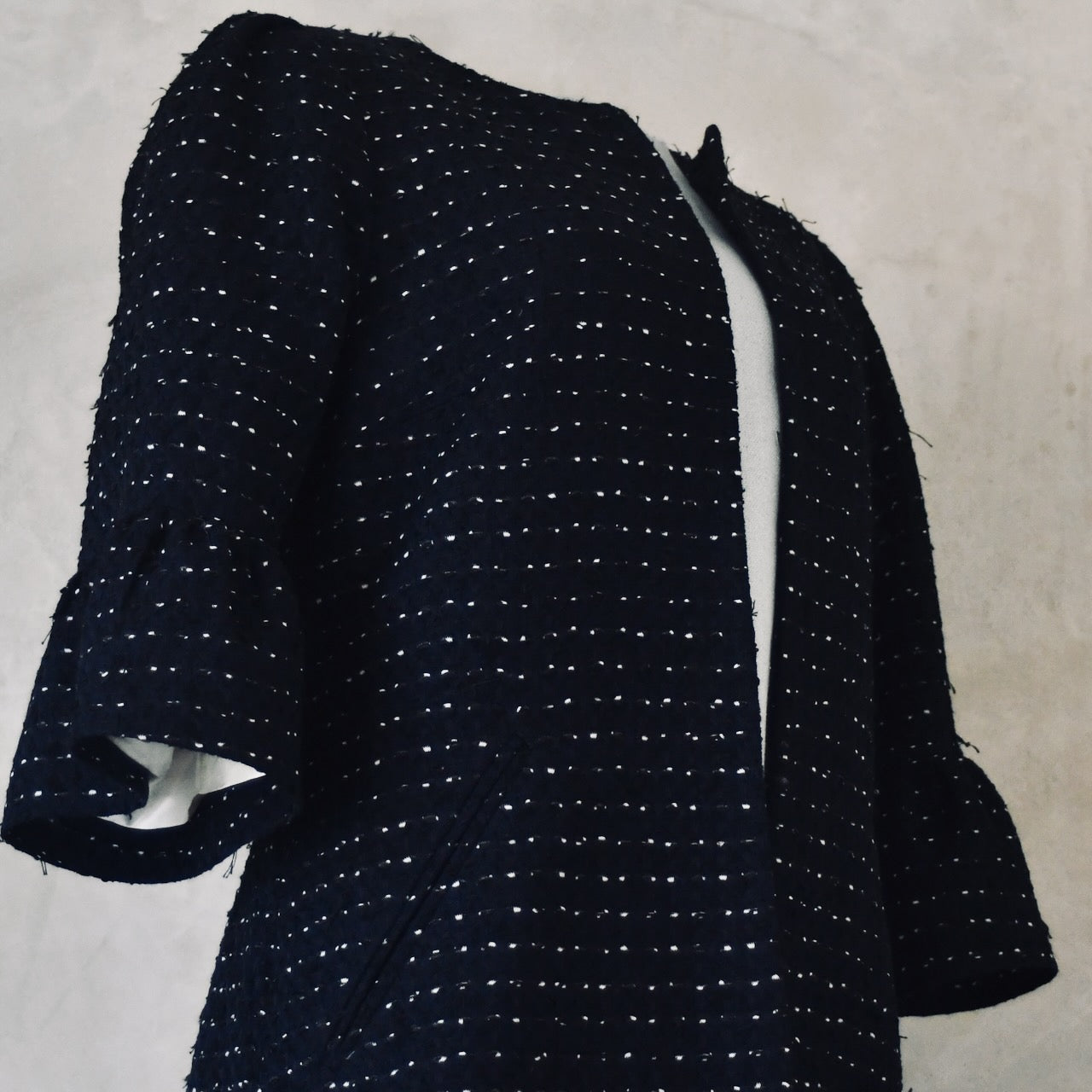 Bespoke Navy Boucle Coat with Bell Sleeves. This is a navy, black, and white cotton boucle fabric from Linton Tweeds. Handmade in Britain. 