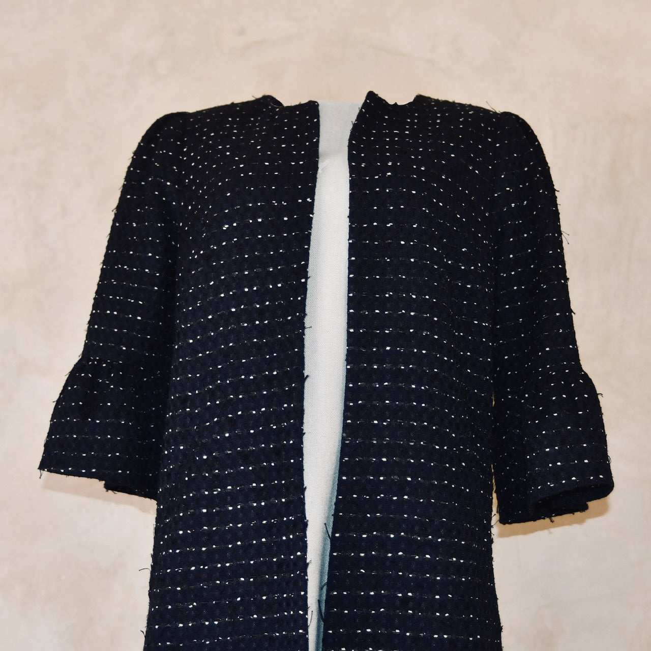 Bespoke Navy Boucle Coat with Bell Sleeves. This is a navy, black, and white cotton boucle fabric from Linton Tweeds. Handmade in Britain. 
