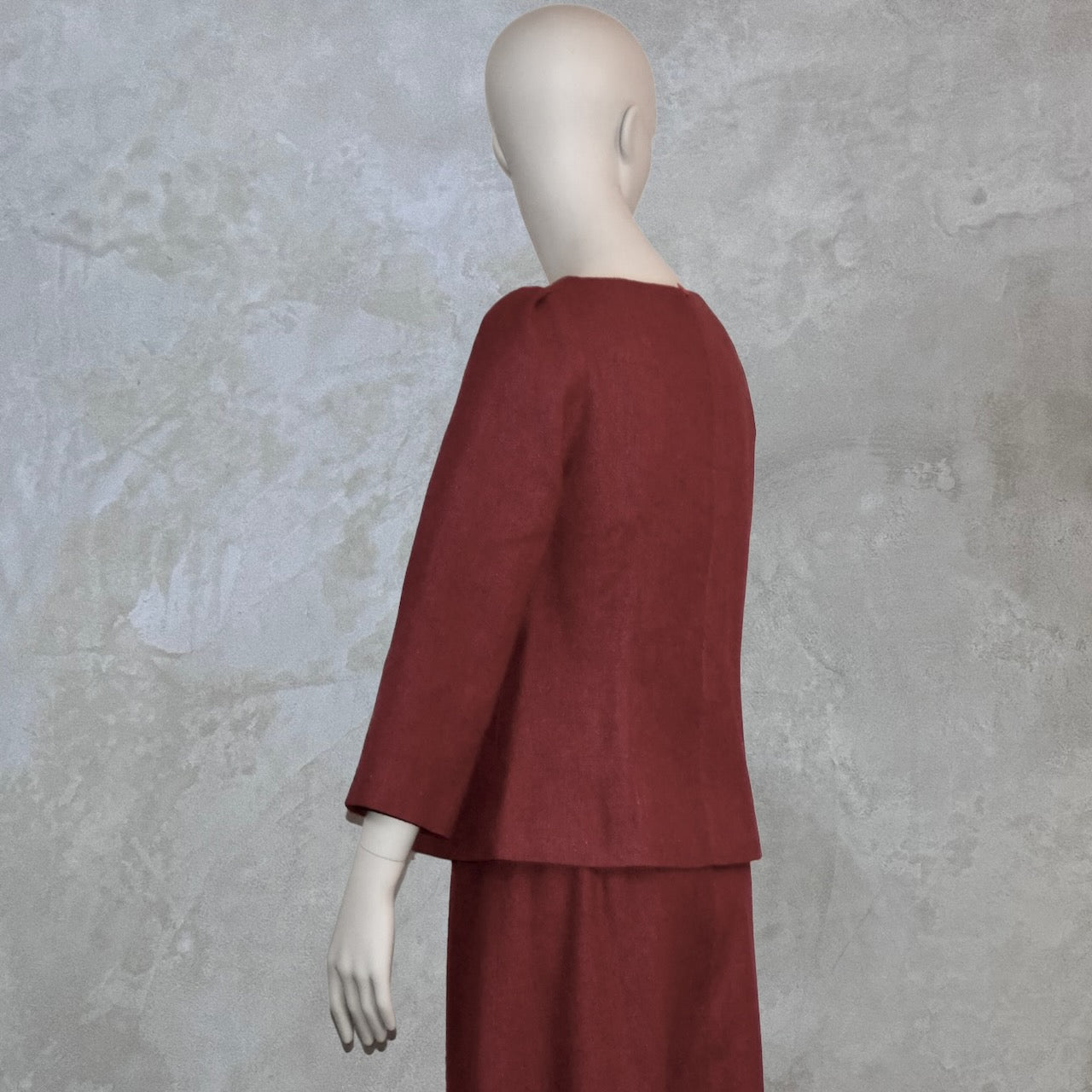 A Tailored Boat Neck Blouse in Dark Pink Silk Matka with a matching skirt, posed sideways. Handmade in Britain.