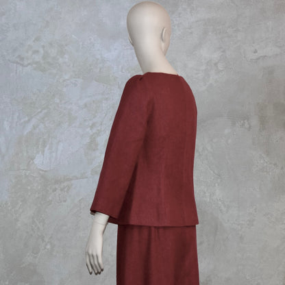 A Tailored Boat Neck Blouse in Dark Pink Silk Matka with a matching skirt, posed sideways. Handmade in Britain.