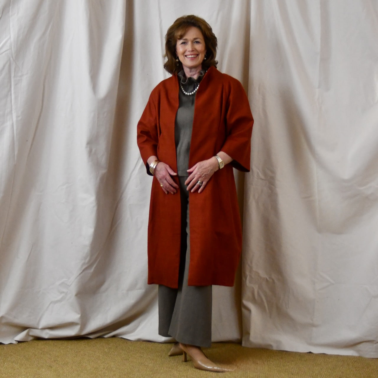 Summer Weight Cocoon Coat in Terracotta Silk. A Bespoke Silk Matka Cocoon Shaped Coat with under-bust and rear gathers, creating a shapely silhoutte.
Handmade in Britain. Standing, Open.
