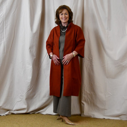 Summer Weight Cocoon Coat in Terracotta Silk. A Bespoke Silk Matka Cocoon Shaped Coat with under-bust and rear gathers, creating a shapely silhoutte.
Handmade in Britain. Standing, Open.