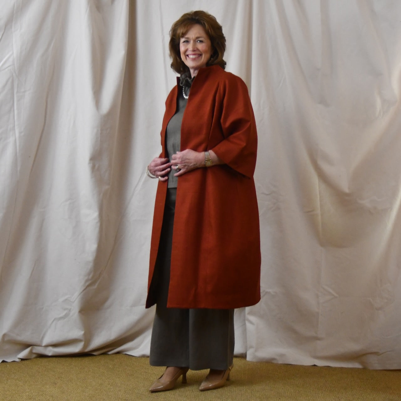 Summer Weight Cocoon Coat in Terracotta Silk. A Bespoke Silk Matka Cocoon Shaped Coat with under-bust and rear gathers, creating a shapely silhoutte.
Handmade in Britain.