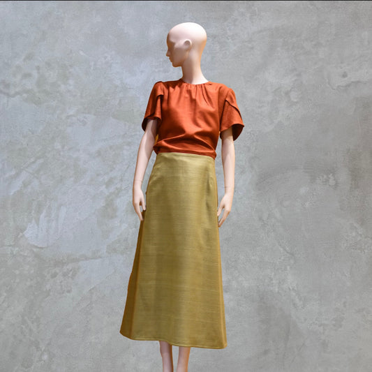 A Tulip Sleeve Blouse in Burnt Brick Silk Matka and a high-waisted, ankle-length mustard green silk matka skirt. Handmade in Britain.