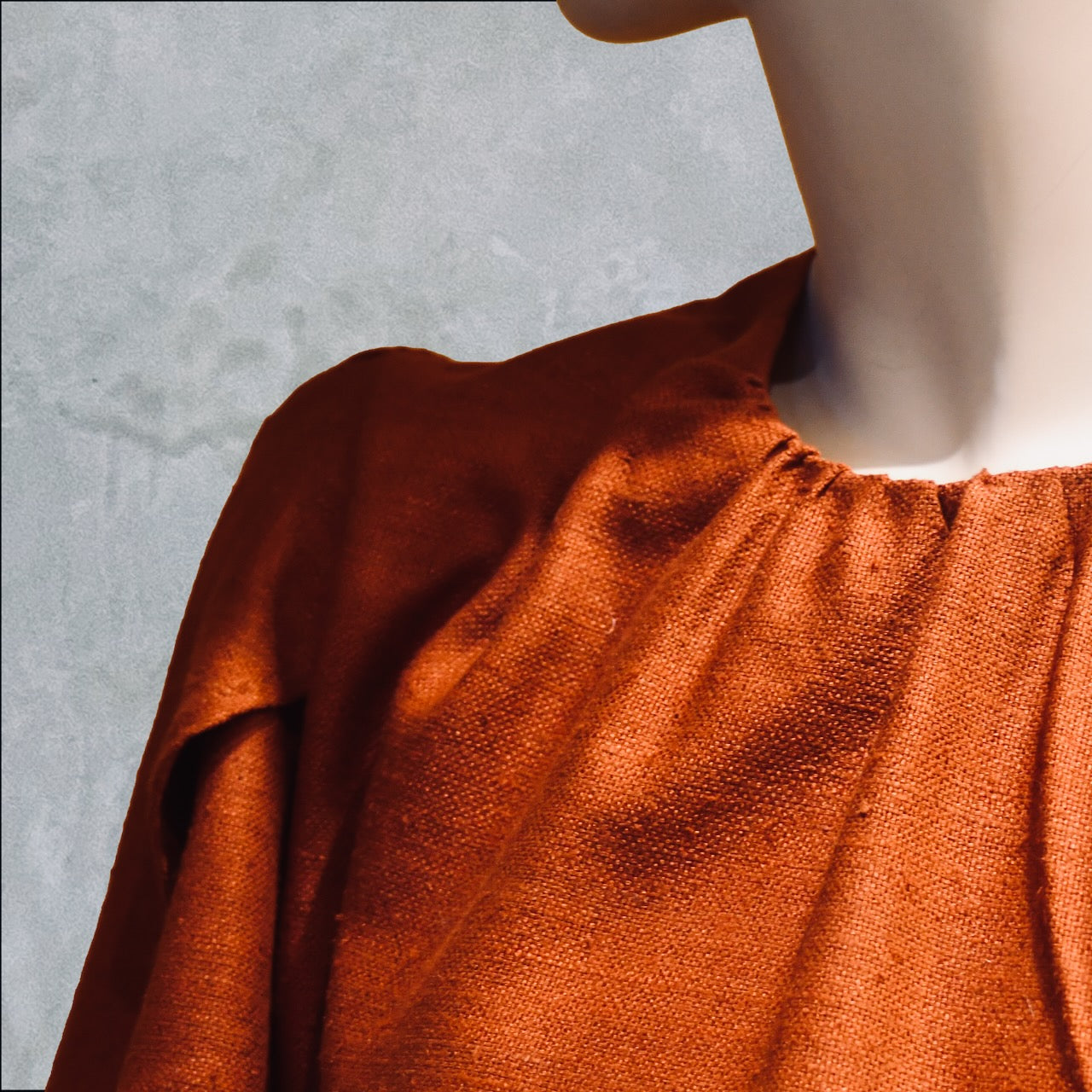 A Tulip Sleeve Blouse in Burnt Brick Silk Matka, featuring a gathered neckline. Handmade in Britain. 