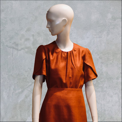 A Tulip Sleeve Blouse in Burnt Brick Silk Matka, featuring a gathered neckline. Handmade in Britain. 