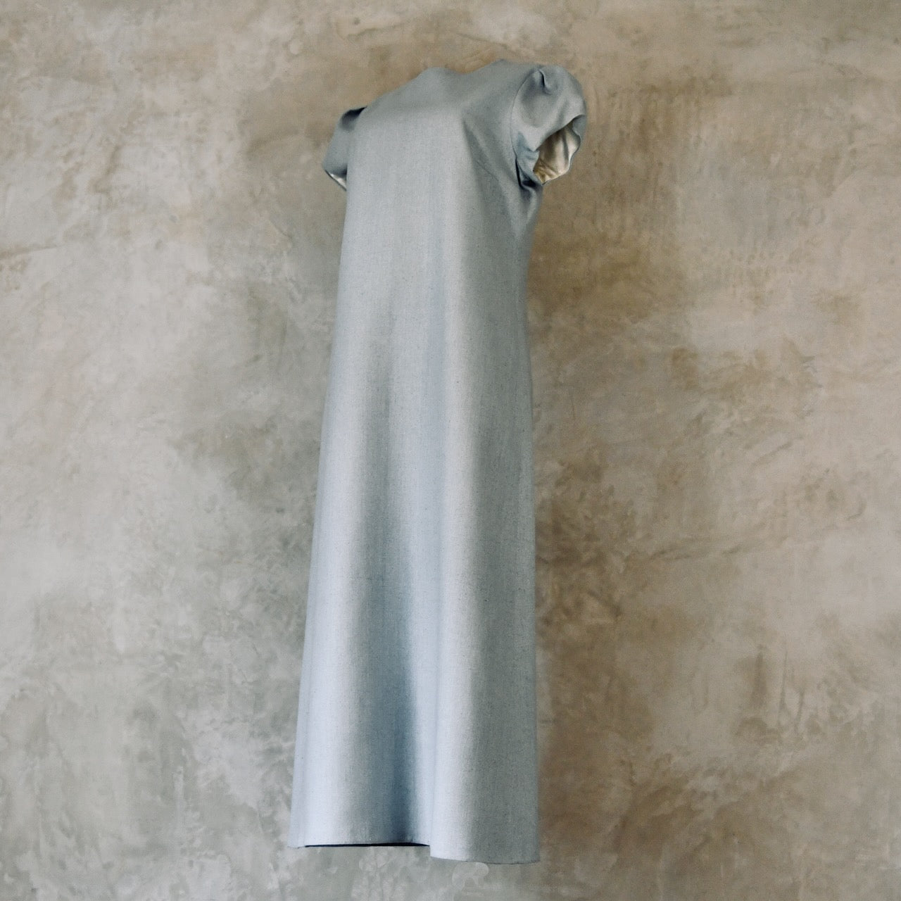 An A-Line Bell Sleeve Coat and Dress in Light Blue Silk Matka. A long, short-sleeved blue woven dress with an A-Line cut. Handmade in Britain. Dress Side View.