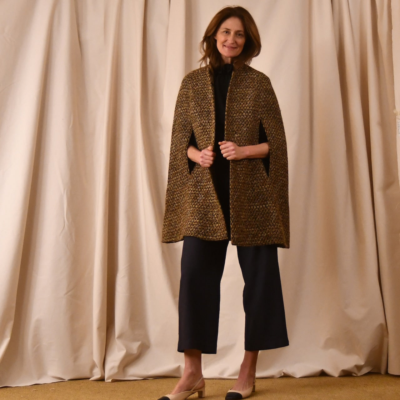 The Long Clayton Cape in Golden Linton Tweeds Boucle. A mid length, easy to wear cape for dressing up or down, mid-season and summer wear. Handmade in Britain.