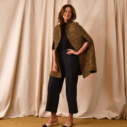Swing Cape in Golden Brown, Black and Camel Boucle from Linton Tweeds. Shown here paired with beige heels. Handmade in Britain. 
