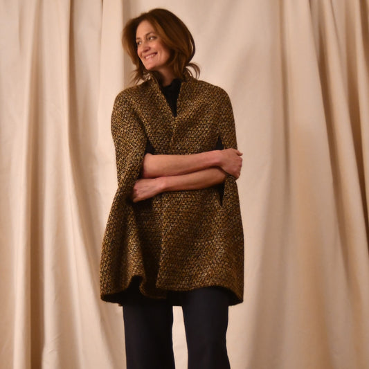 The Long Clayton Cape in Golden Linton Tweeds Boucle. A mid length, easy to wear cape for dressing up or down, mid-season and summer wear. Handmade in Britain.