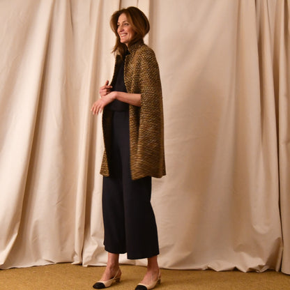 The Long Clayton Cape in Golden Linton Tweeds Boucle. A mid length, easy to wear cape for dressing up or down, mid-season and summer wear. Handmade in Britain. Side View