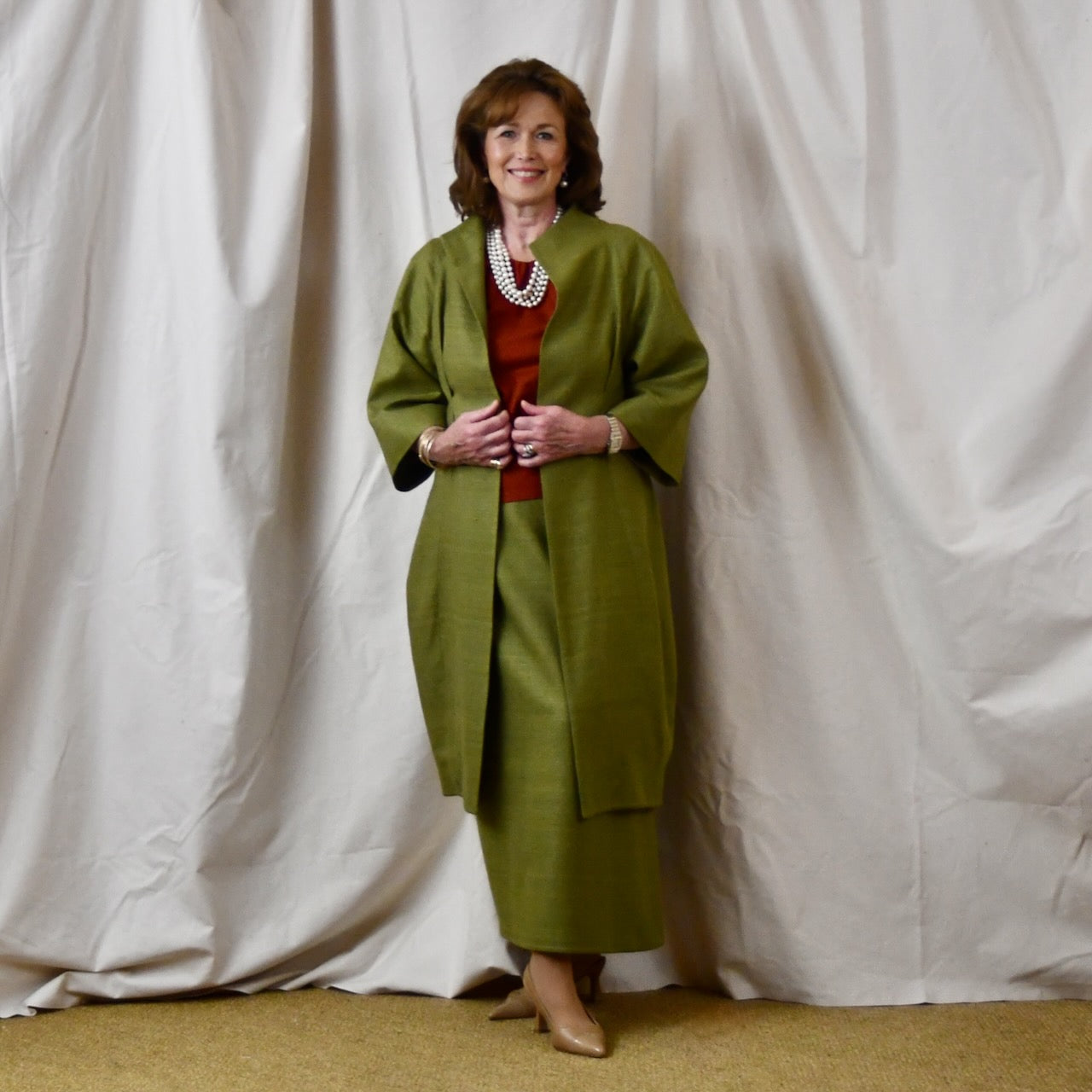 Green Silk Summer Weight Cocoon Coat with under-bust gathers and gather detail at rear. Handmade in Britain. Shown With Burnt Brick Tulip Sleeve Top.