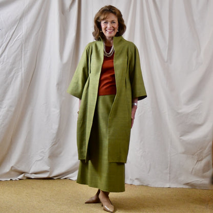 Green Silk Summer Weight Cocoon Coat with under-bust gathers and gather detail at rear. Handmade in Britain. Shown with Burnt Brick Matka Top and Matching Skirt.