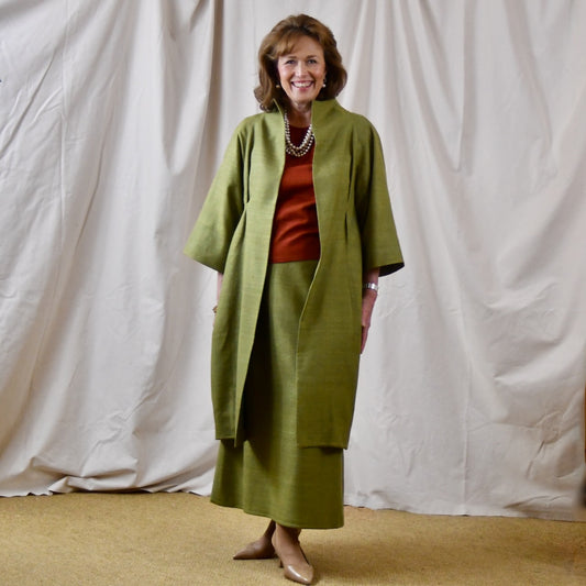 Green Silk Summer Weight Cocoon Coat with under-bust gathers and gather detail at rear. Handmade in Britain. Shown with Burnt Brick Matka Top and Matching Skirt.