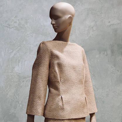 A Tailored Boat Neck Suit in Sand Mix Boucle from Linton Tweeds. Featuring structured seams for a flattering line. Handmade in Britain. 