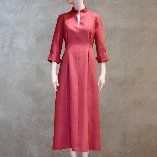 Formal summer dress in pure silk. Handmade in London this pink dress has a nipped in waist, mid length sleeves, turn back cuffs and gently flattering inverted darts at the rear. Slits to the side and an open neckline with a Nehru collar. 