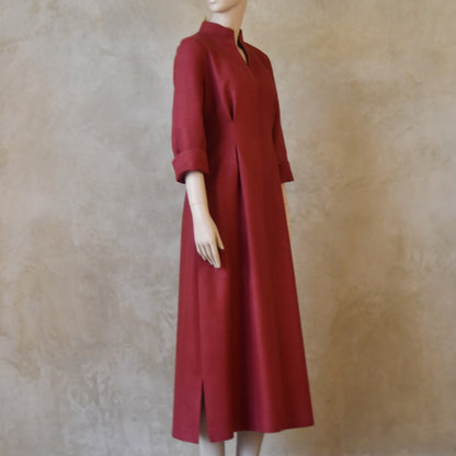 Side shot of Formal silk dress. Handmade in London this pink dress has a nipped in waist, mid length sleeves, turn back cuffs and gently flattering inverted darts at the rear. Slits to the side and an open neckline with a Nehru collar. 
