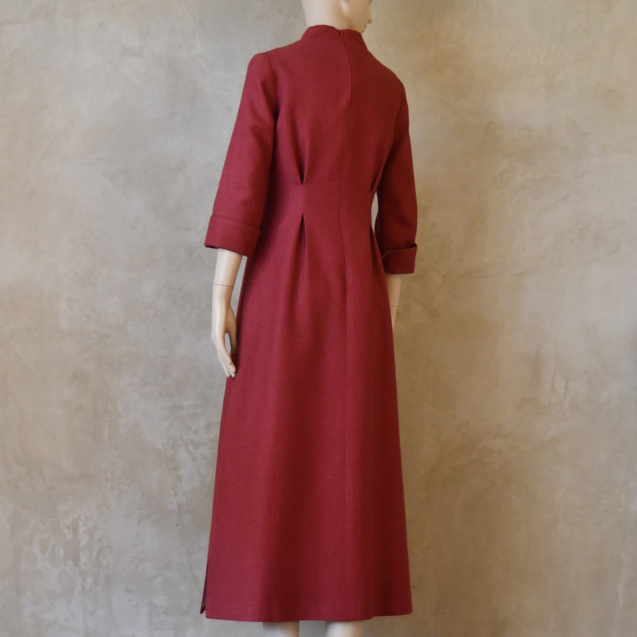 Angled back view of Dark Pink Silk Waisted longer length mid-season tailored dress. Ready to Ship and Made to order. Sizes 6 to 20 and bespoke. Made by hand in East London.