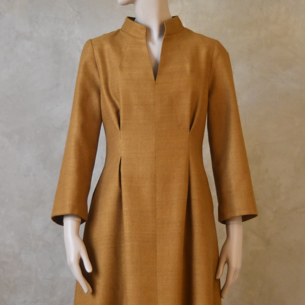 Close up shot of Tan coloured tailored silk dress. Handmade in London.