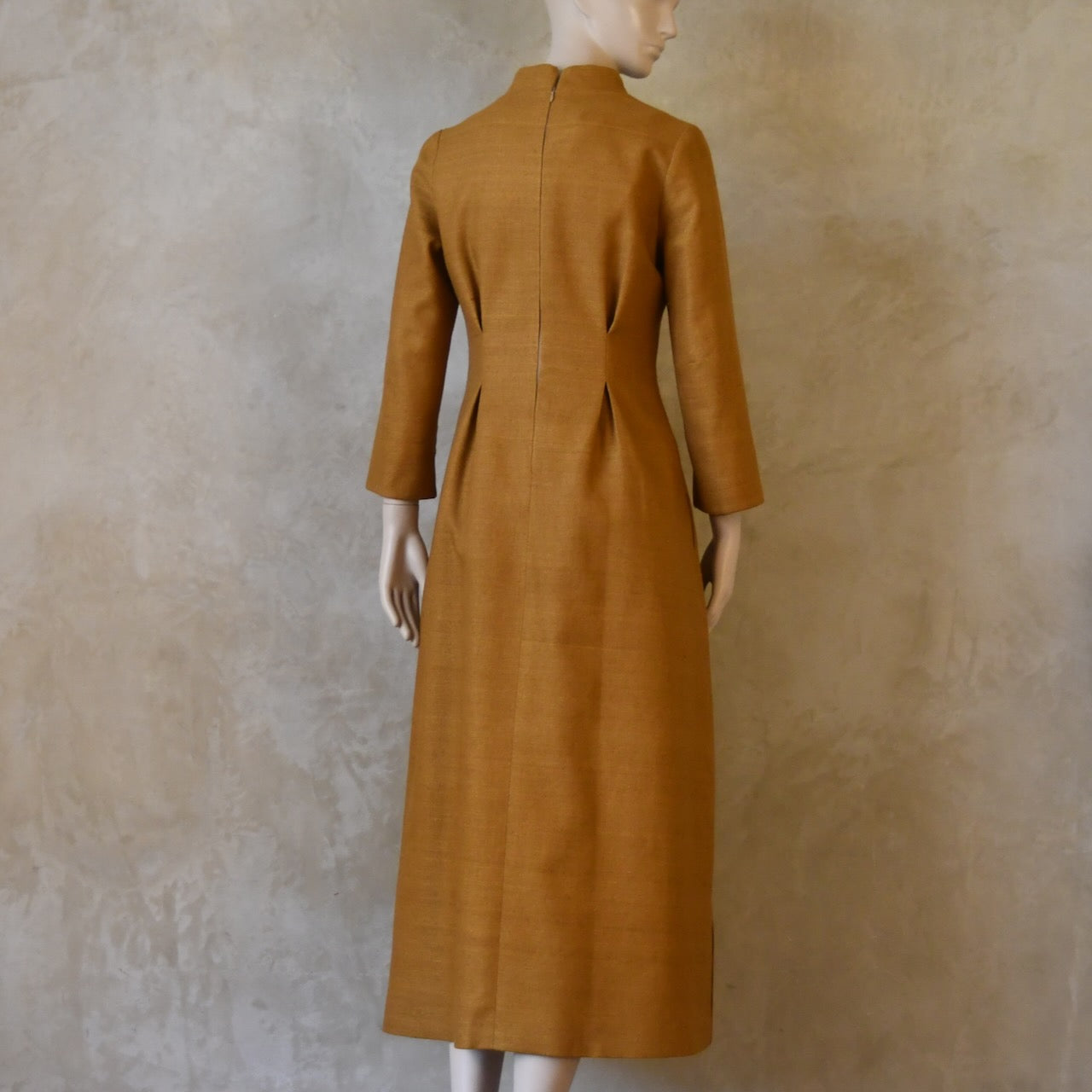 Rear view of Tan coloured tailored formal wear silk dress. Three quarter length sleeves, fully lined in silk with gathering darts at front and rear creating flattering hourglass shape. Handmade in London.