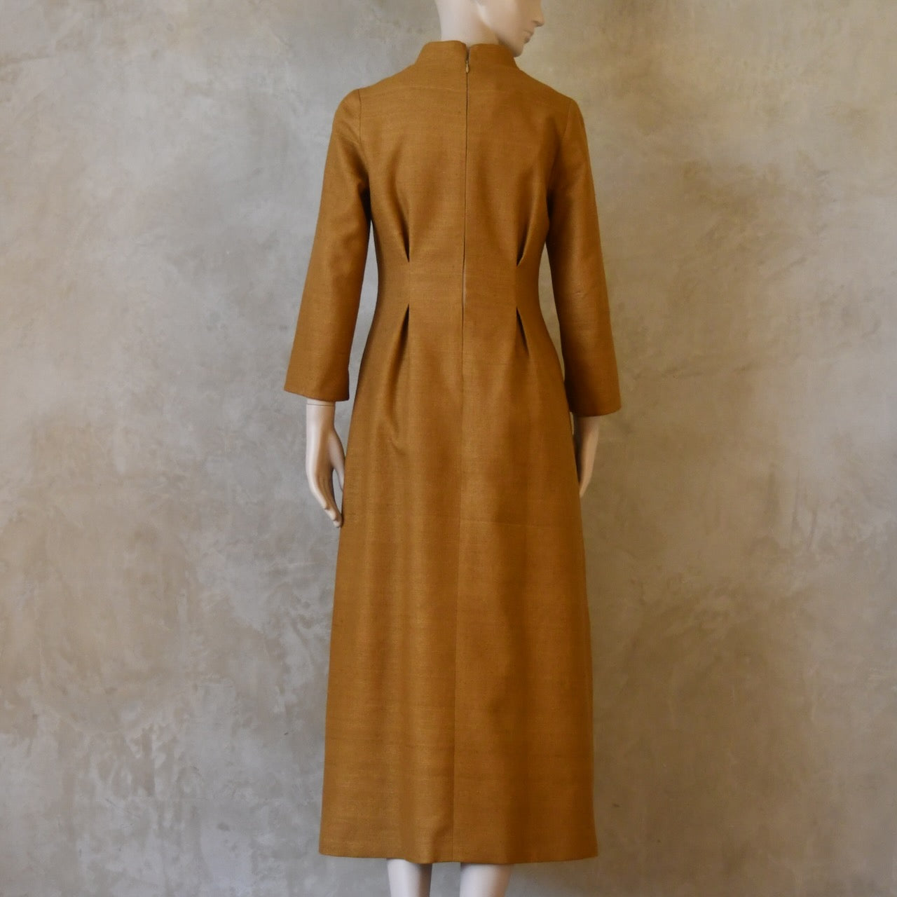 Back shot of Tan coloured tailored formal wear silk dress. Three quarter length sleeves, fully lined in silk with gathering darts at front and rear creating flattering hourglass shape. Handmade in London.