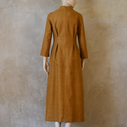 Back shot of Tan coloured tailored formal wear silk dress. Three quarter length sleeves, fully lined in silk with gathering darts at front and rear creating flattering hourglass shape. Handmade in London.