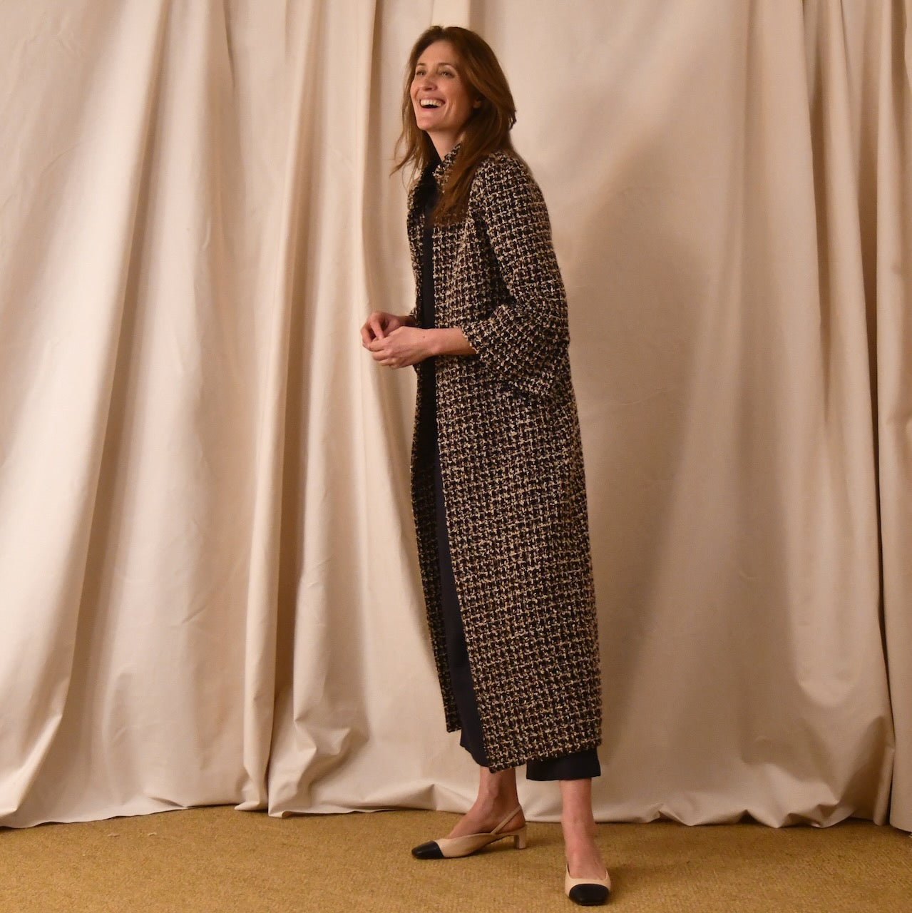 Bespoke Bell Sleeve A-Line Coat in Check Linton Tweeds Boucle. Longer length ivory check boucle coat with frill cuff detail on sleeve – the perfect coat for evening wear and smart occasions. Made in Britain.