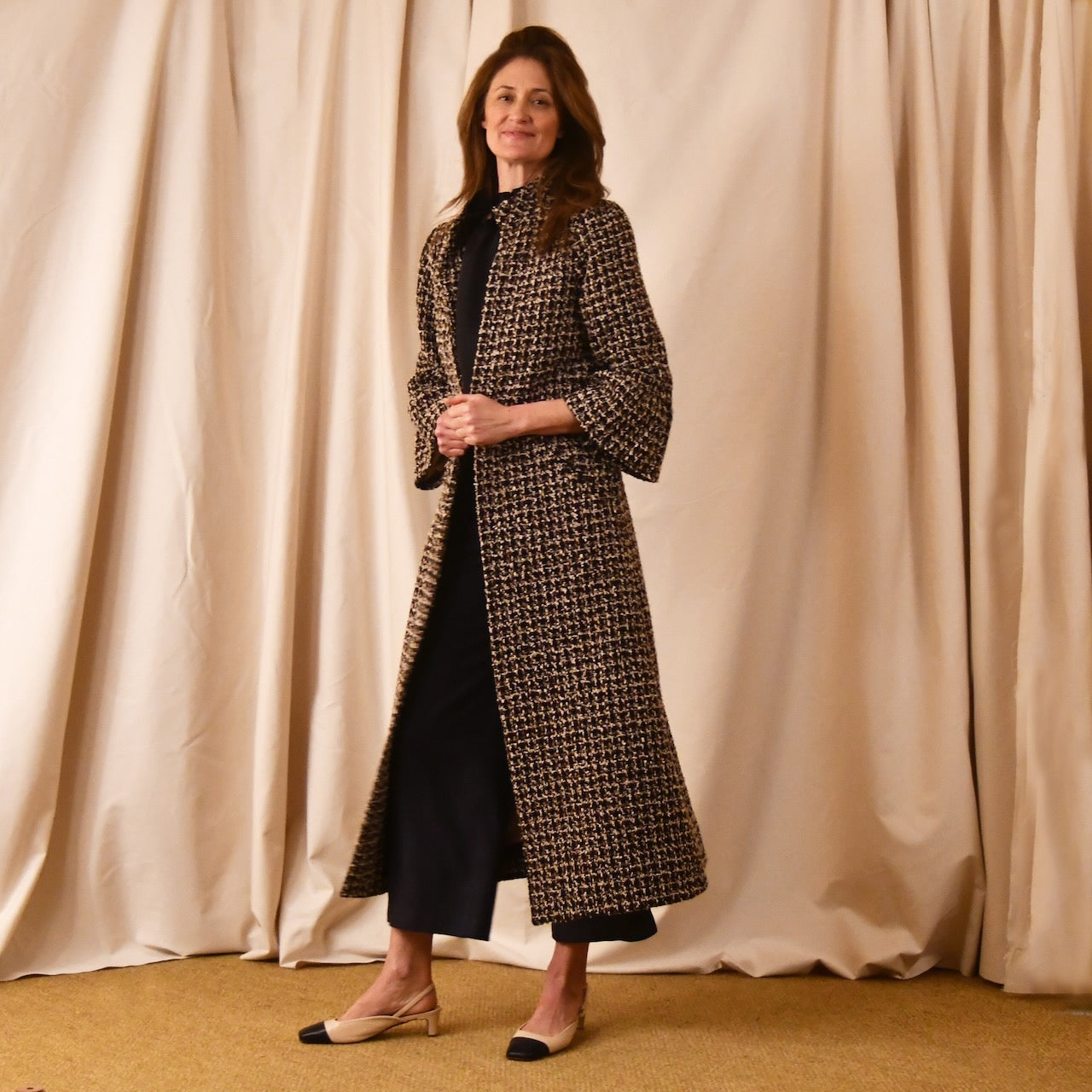Bell Sleeve A-Line Coat in Check Linton Tweeds Boucle. Longer length ivory check boucle coat with frill cuff detail on sleeve – the perfect coat for evening wear and smart occasions. Entirely made in Great Britain.