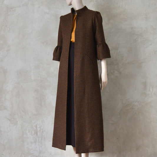 Bespoke Merino Flannel Coat by EdNerat. Handmade in London, this A-Line longer length coat has gathered details at the shoulders, bell sleeves and is lined in pure silk. Woven in Somerset  by Fox Brothers and Handmade in London. Shown over Brown Merino Wool A-Line Skirt.