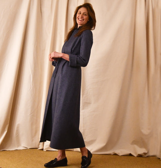 Fitted and Flared Tailored Coat in Blue Herringbone Tweed. Denim-blue in colour with delicate patterning this is a sophisticated textile which flatters the pattern. Perfect for racing and winter events. Handmade in Britain. Belted Side View.