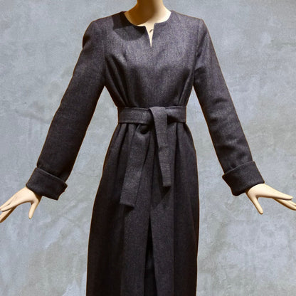 Fitted and tailored hourglass coat in Denim Blue Herringbone Lambswool Tweed over a matching long skirt. Handmade in Britain. Shown Belted.