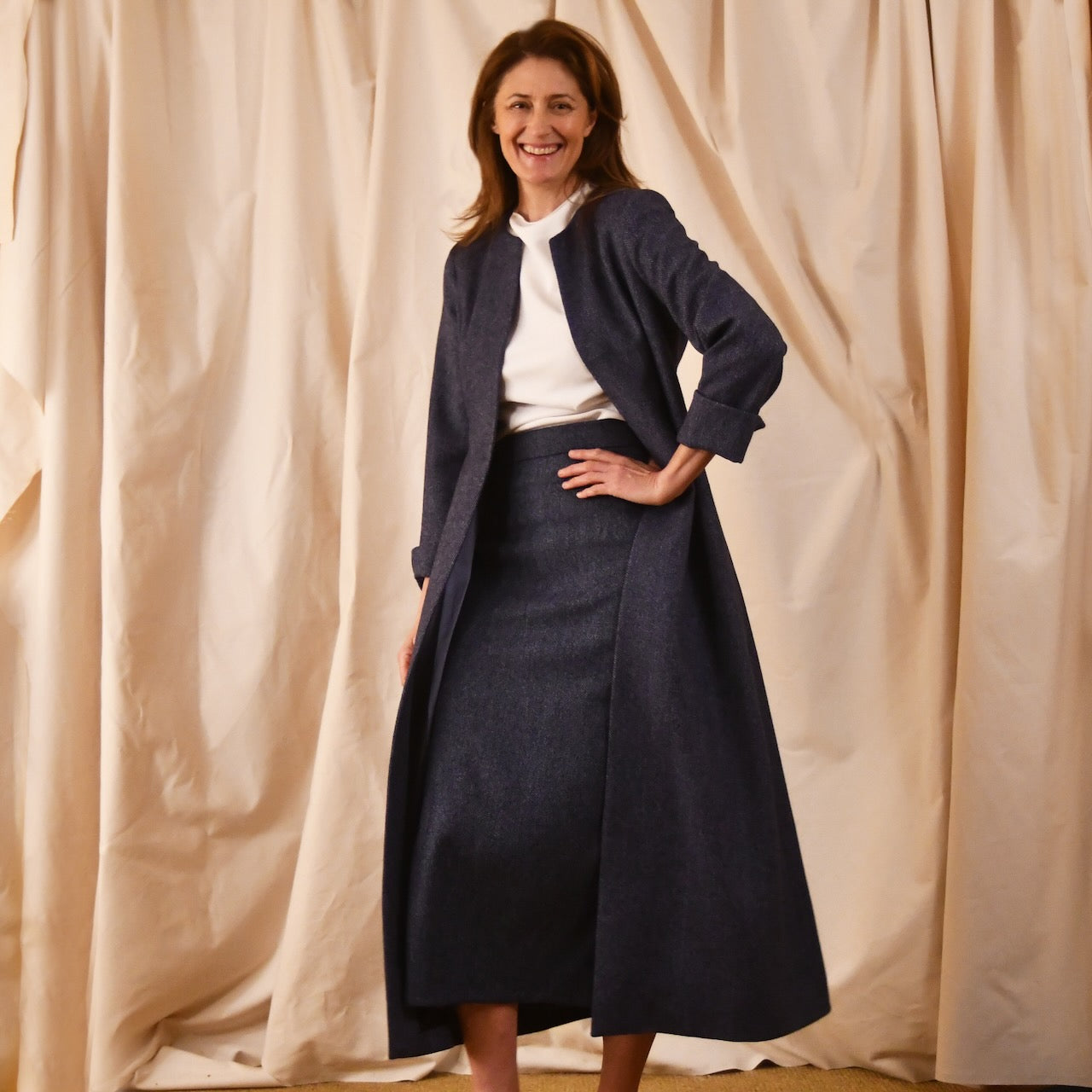 Fitted and tailored hourglass coat in Denim Blue Herringbone Lambswool Tweed over a matching long skirt. Handmade in Britain. Open View.