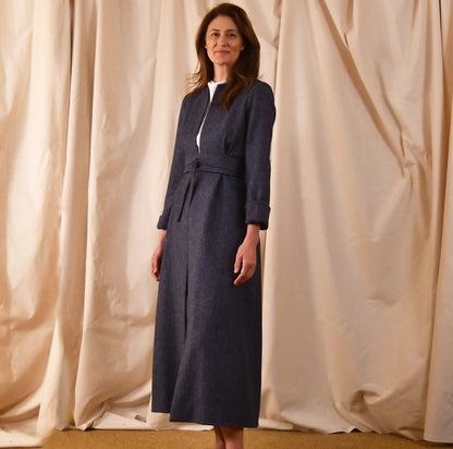 Fitted and tailored hourglass coat in Denim Blue Herringbone Lambswool Tweed over a matching long skirt. Handmade in Britain. Closed View.
