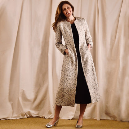 The Fitted Hourglass Coat in Camel, Black and White Flag Textured Bouclé from Linton Tweeds. A Fitted Summer Bouclé Coat investment piece, for Royal Ascot and Summer Occasions. Handmade in Britain. Front View.