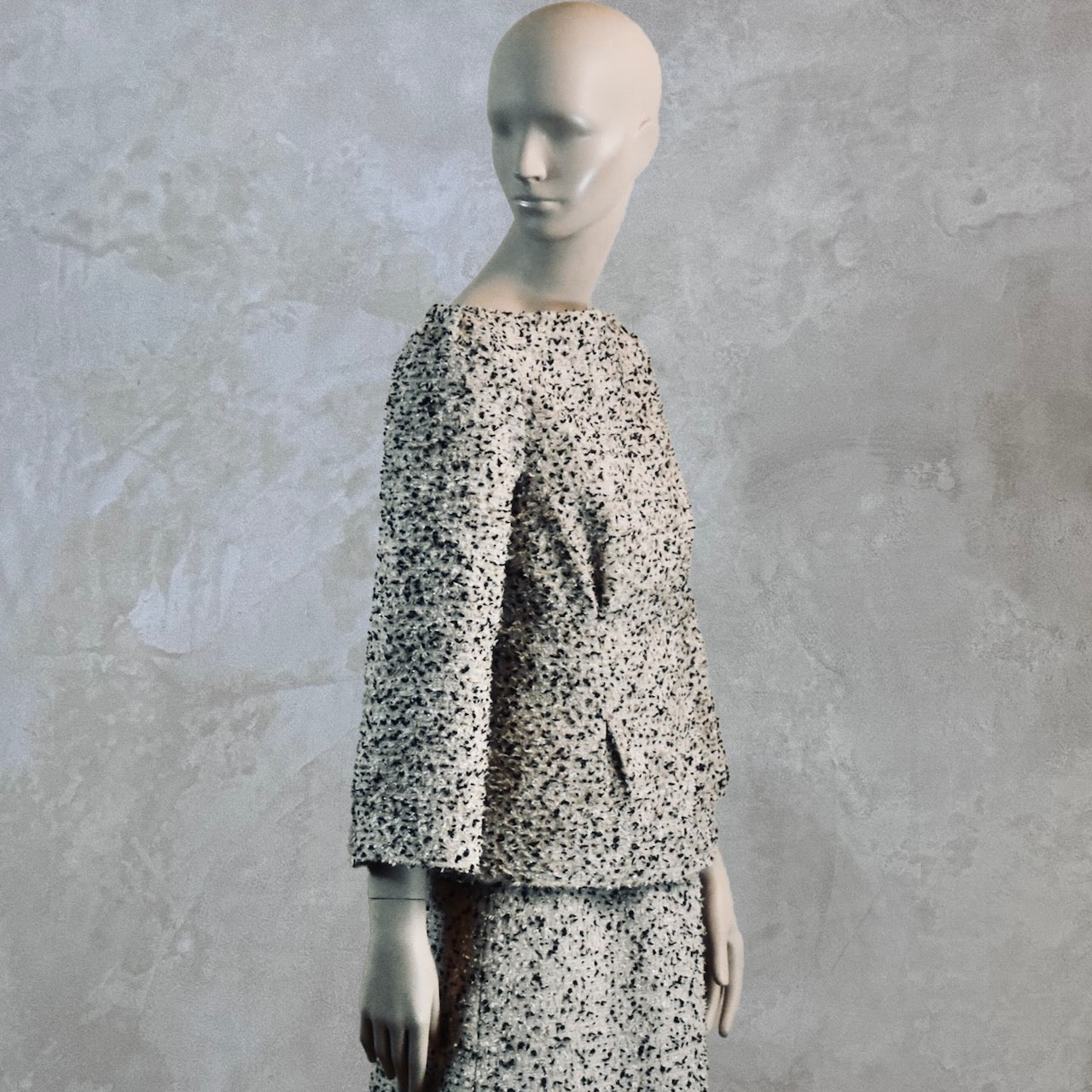 A Tailored Boat Neck Blouse in Linton Tweeds Boucle and a matching calf-length skirt. A chic, light-hued two-piece with long sleeves. Handmade in Britain.