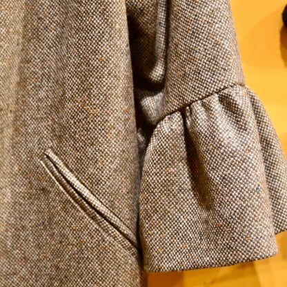 Bell Sleeve A-Line Coat in Moss Green Tweed. A longer length A-Line cut tweed coat with shoulder and cuff detail. This investment piece will last for years thanks to the quality of the yarn and tight weave in this Yorkshire Tweed.