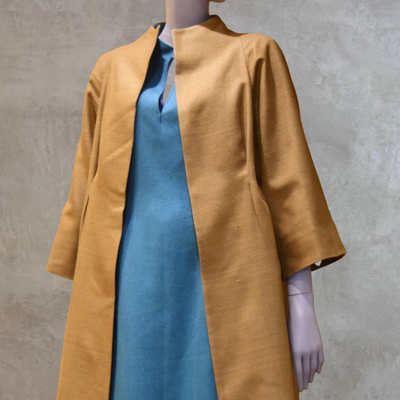 Close up of the Raglan Sleeve on the EdNerat Silk Cocoon Coat in Tan. A mid length summer coat, perfect for throwing over the most relaxed of outfits. Handmade in London.
