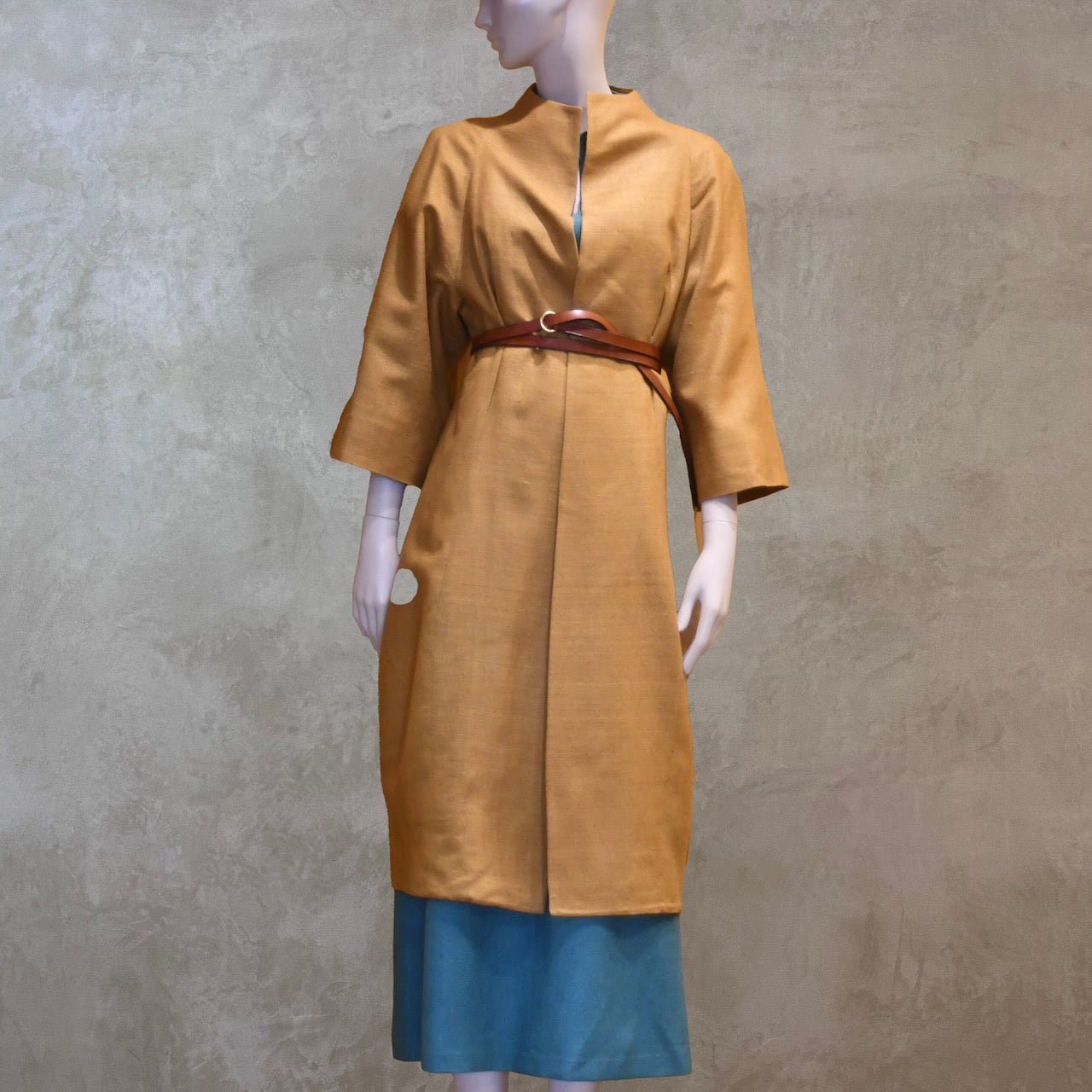 Summer silk cocoon coat in tan silk makta. Fully lined in silk and handmade in London, this coat is a perfect summer weight and can be worn open or belted as shown in the photograph.