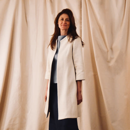 Trapeze Swing Coat in White Silk Boucle
White MidLength Swing Coat with slight vintage feel and flattering seaming details to front and rear. The perfect transitional piece - smart enough for the best occasions, easy enough to wear every day. Handmade in Great Britain. Side View.