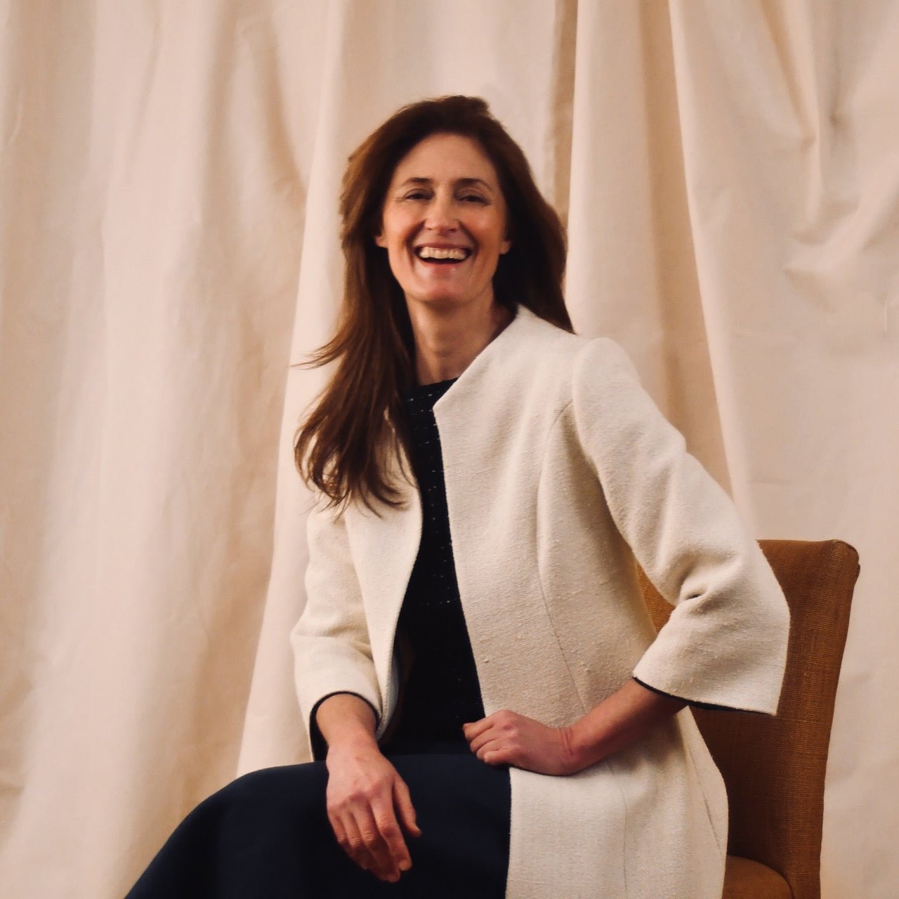 Trapeze Swing Coat in White Silk Boucle
White MidLength Swing Coat with slight vintage feel and flattering seaming details to front and rear. The perfect transitional piece - smart enough for the best occasions, easy enough to wear every day. Handmade in Great Britain. Seated View.