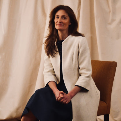 Trapeze Swing Coat in White Silk Boucle
White MidLength Swing Coat with slight vintage feel and flattering seaming details to front and rear. The perfect transitional piece - smart enough for the best occasions, easy enough to wear every day. Handmade in Great Britain. Seated Side View.